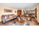 Inviting living room with hardwood floors, cozy sofa, armchairs, and staircase leading to upper level at 225 Briscoe Ln, Castle Rock, CO 80109