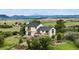 Spacious house with multiple balconies overlooking the expansive backyard and mountain scenery at 225 Briscoe Ln, Castle Rock, CO 80109