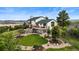 Rear exterior showcasing the deck, well-maintained lawn, and landscaped areas at 225 Briscoe Ln, Castle Rock, CO 80109