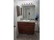 Bathroom featuring a vanity with wood cabinets and a framed mirror at 14500 E 2Nd Ave # 209A, Aurora, CO 80011