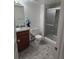 Bathroom with a glass-enclosed shower, toilet, and a vanity with ample storage at 14500 E 2Nd Ave # 209A, Aurora, CO 80011