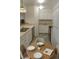 A compact kitchen features white cabinets and dining area with seating for three at 14500 E 2Nd Ave # 209A, Aurora, CO 80011