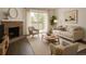 Bright living room features a brick fireplace, balcony access, and comfortable seating at 14500 E 2Nd Ave # 209A, Aurora, CO 80011