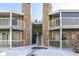 Condo building exterior with snowy landscape and stairs at 943 S Zeno Way # 206, Aurora, CO 80017