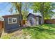 Backyard features two shed with a wooden fence, beautiful yard and green grass at 300 E Cleveland St, Lafayette, CO 80026