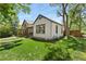 Exterior side view of home with green lawn, mature tree and nice landscaping at 300 E Cleveland St, Lafayette, CO 80026