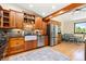 Well-equipped kitchen featuring stainless steel appliances, hardwood floors, and custom cabinets at 300 E Cleveland St, Lafayette, CO 80026