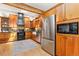 Well-lit kitchen showcasing stainless steel appliances, wood cabinets, farmhouse sink, and hardwood floors at 300 E Cleveland St, Lafayette, CO 80026