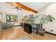Open living area featuring a dining area, hardwood floors, beam, and a large window with a view at 300 E Cleveland St, Lafayette, CO 80026