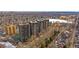 High-rise apartment buildings surrounded by trees, offering a scenic view of the city and a frozen lake, creating a winter wonderland at 460 S Marion Pkwy # 251, Denver, CO 80209
