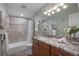 Inviting bathroom with a granite countertop, wooden cabinets, and a shower-tub combination at 460 S Marion Pkwy # 251, Denver, CO 80209