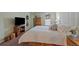 Cozy bedroom with ample natural light, custom bedframe storage, and classic wooden furniture at 460 S Marion Pkwy # 251, Denver, CO 80209