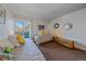 Well-lit bedroom with two beds, balcony access, and colorful decorations, creating a vibrant space at 460 S Marion Pkwy # 251, Denver, CO 80209