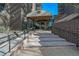 Elegant building entrance with a covered walkway, grand canopy, and brick accents, providing a prestigious welcome at 460 S Marion Pkwy # 251, Denver, CO 80209