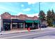 Charming brick storefront with a Starbucks Coffee and Bang Salon, enhanced by awnings and streetscape at 460 S Marion Pkwy # 251, Denver, CO 80209