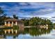 Picturesque lakefront park building with classical architecture, surrounded by lush greenery and scenic water views for leisure at 460 S Marion Pkwy # 251, Denver, CO 80209