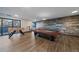 Spacious game room with a ping pong table, foosball table, and stylish plank accent wall, perfect for entertainment at 460 S Marion Pkwy # 251, Denver, CO 80209