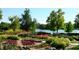 Beautiful gardens with colorful flowers and greenery surrounding a tranquil lake in a park at 460 S Marion Pkwy # 251, Denver, CO 80209
