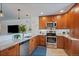 Modern kitchen featuring granite countertops, stainless steel appliances, custom cabinets and tiled backsplash at 460 S Marion Pkwy # 251, Denver, CO 80209