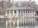 Lake view with building in background, framed by magnolia branches at 460 S Marion Pkwy # 251, Denver, CO 80209