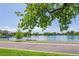Scenic lake view framed by lush green trees and blue sky, showcasing a peaceful park setting at 460 S Marion Pkwy # 251, Denver, CO 80209
