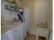 Functional laundry room with washer, dryer, and utility sink at 1057 English Sparrow Trl, Highlands Ranch, CO 80129