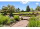 Beautiful backyard space includes landscaping, a stone retaining wall, and patio area at 7345 W 97Th Pl, Broomfield, CO 80021