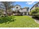 Manicured lawn and backyard offers an elevated wood deck with stairs to a concrete patio at 7345 W 97Th Pl, Broomfield, CO 80021