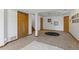 Open basement area with neutral carpeting, white walls, wood trim and decorative rug at 7345 W 97Th Pl, Broomfield, CO 80021