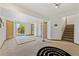 Spacious basement area features neutral carpeting, a sliding glass door, and stairs to upper levels at 7345 W 97Th Pl, Broomfield, CO 80021