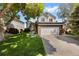 Charming two-story home with a well-manicured lawn, mature trees, and a spacious two-car garage at 7345 W 97Th Pl, Broomfield, CO 80021