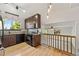 Modern kitchen with stainless steel appliances, granite countertops, and an adjacent dining area with hardwood floors at 7345 W 97Th Pl, Broomfield, CO 80021