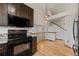Functional kitchen space with modern appliances, adjacent to an open living area with hardwood flooring and natural light at 7345 W 97Th Pl, Broomfield, CO 80021