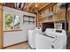 Bright laundry area boasts modern washer and dryer units and a sunny window at 7345 W 97Th Pl, Broomfield, CO 80021