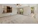 Open living room with a slider to the backyard deck and neutral carpeting at 7345 W 97Th Pl, Broomfield, CO 80021