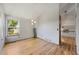 Bright living area with hardwood floors, contemporary lighting fixtures, and a glimpse of the staircase at 7345 W 97Th Pl, Broomfield, CO 80021