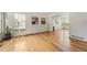 Open-concept living area with gleaming hardwood floors, large windows, and a neutral color palette at 7345 W 97Th Pl, Broomfield, CO 80021