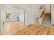 Spacious living area with hardwood floors, staircase access, and ample natural light from large windows at 7345 W 97Th Pl, Broomfield, CO 80021