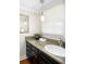 Charming bathroom featuring granite countertops, dark wood cabinetry, and natural light at 2134 S Jackson St, Denver, CO 80210