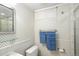Traditional bathroom with patterned wallpaper, shower and a large mirror above the sink at 2134 S Jackson St, Denver, CO 80210