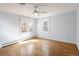 Well-lit bedroom featuring hardwood floors, a ceiling fan, and natural light at 2134 S Jackson St, Denver, CO 80210