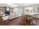 Spacious living room with fireplace, built-in bookshelves, hardwood floors, and an abundance of natural light at 2134 S Jackson St, Denver, CO 80210