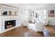 Bright living room with a fireplace, modern furniture, and hardwood flooring at 2134 S Jackson St, Denver, CO 80210