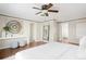 Bright main bedroom boasts hardwood floors, stylish decor, and a ceiling fan for added comfort at 2134 S Jackson St, Denver, CO 80210