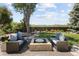 Well maintained backyard featuring comfortable seating around a modern stone fire pit at 9383 W Colorado Ave, Lakewood, CO 80232