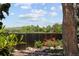 A view of a backyard fence with decorative metal artwork surrounded by lush landscaping at 9383 W Colorado Ave, Lakewood, CO 80232