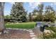 Beautiful backyard featuring a well maintained lawn, dining set, and lounge seating around a fire pit at 9383 W Colorado Ave, Lakewood, CO 80232
