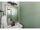 Bathroom with white vanity, large mirror, and olive green walls providing a vintage feel at 9383 W Colorado Ave, Lakewood, CO 80232