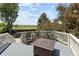 Deck overlooking landscape, featuring a bar with seating and a modern fire pit table at 9383 W Colorado Ave, Lakewood, CO 80232