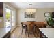 Dining area with modern lighting, stylish decor, hardwood floors, and access to the outdoor patio at 9383 W Colorado Ave, Lakewood, CO 80232
